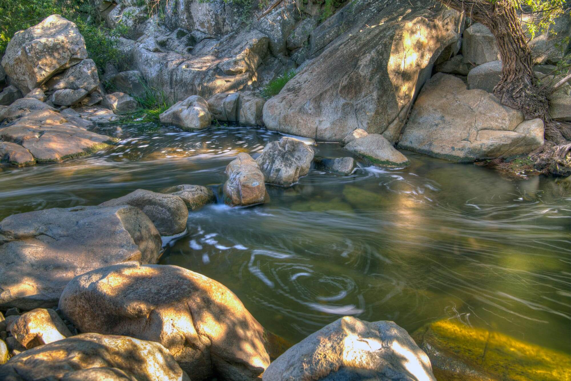 Swirling water at the end of waterfall in Elfin Forest Recreational Reserve
